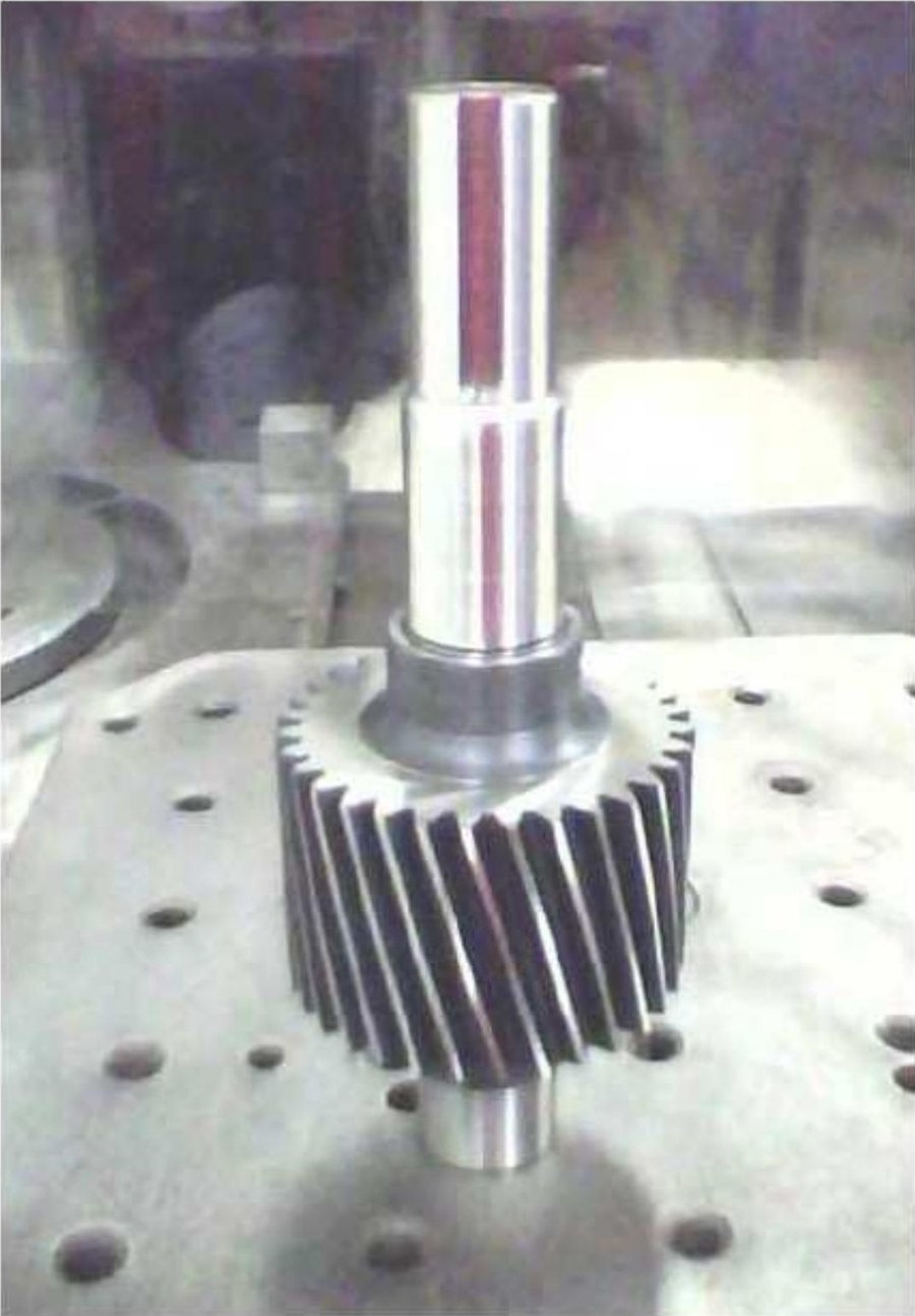 Machined helical pinion set on the machine table